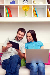 man and woman looking at the tablet pc