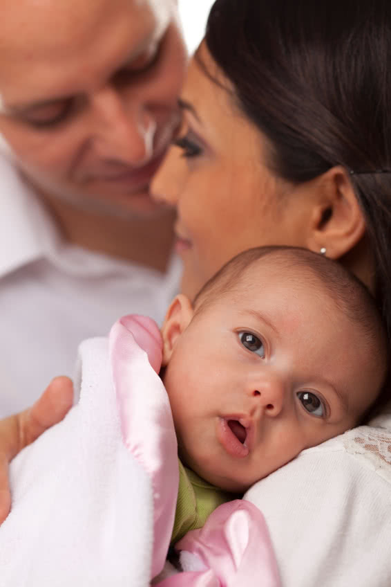 Happy Young Attractive Mixed Race Family with Newborn Baby.