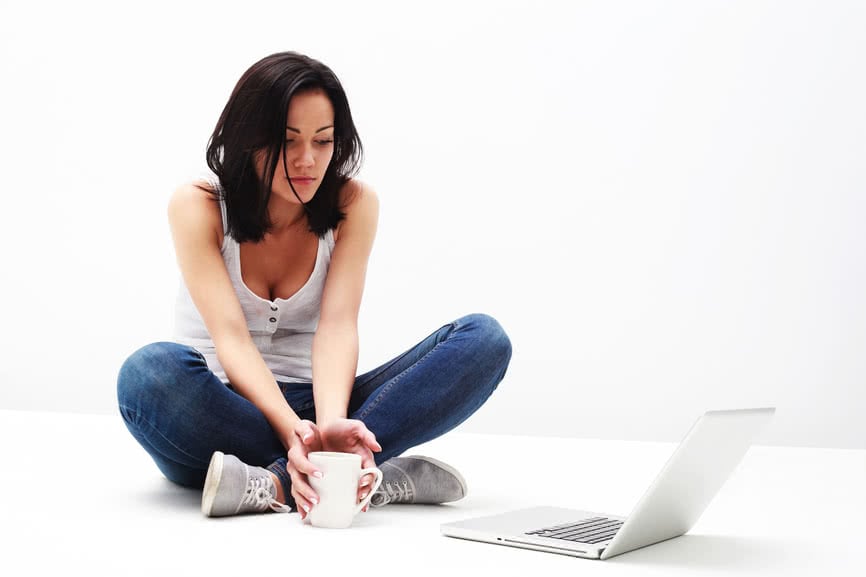 Portrait of pretty young girl looking at laptop