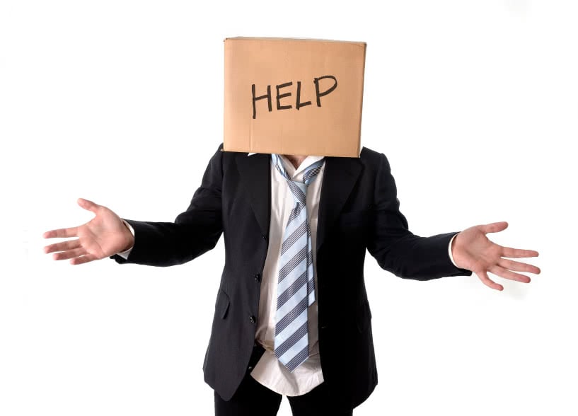 Business man asking for help with carboard box on his head isolated on white background