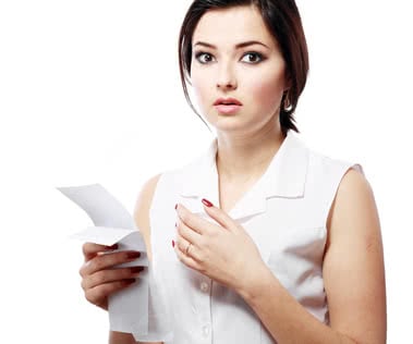 young woman shocking after checking over the receipt in her hands and spending too much