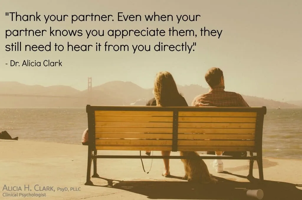 Two people sitting on a bench overlooking a bay with a bridge in the distance, with a quote about thanking your partner.