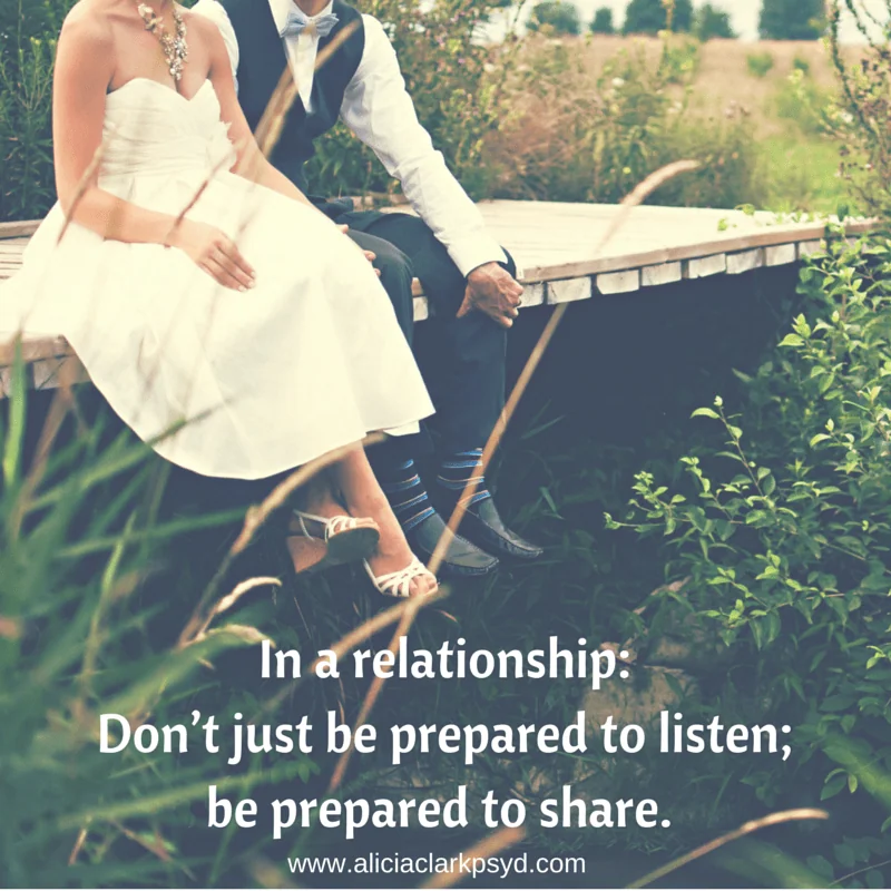Bride and groom sitting on wooden bench overlooking fields with relationship advice text overlay