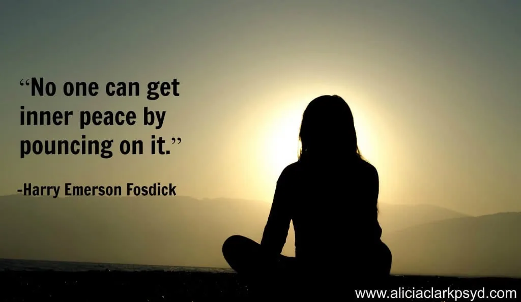 Silhouette of person sitting in meditation pose at sunset with quote about inner peace by Harry Emerson Fosdick