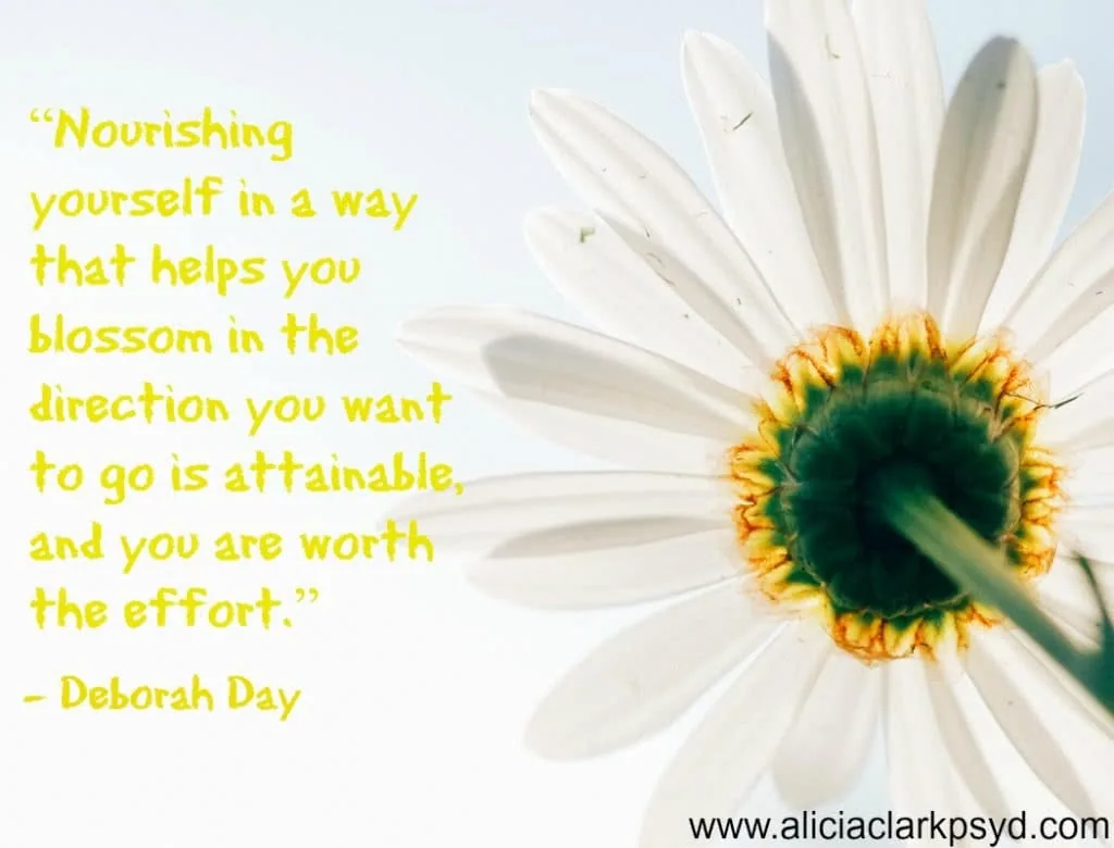White daisy with yellow center against light blue sky, with yellow inspirational quote by Deborah Day about self-nourishment