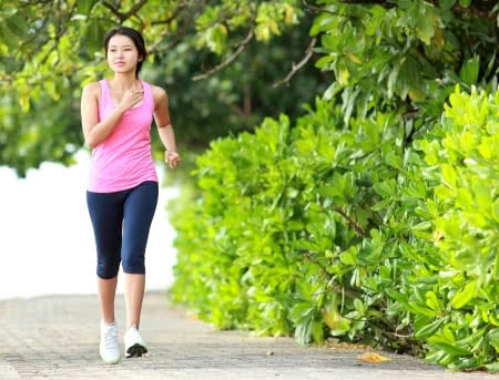 25348477 - beautiful fitness model in pink running on the beach