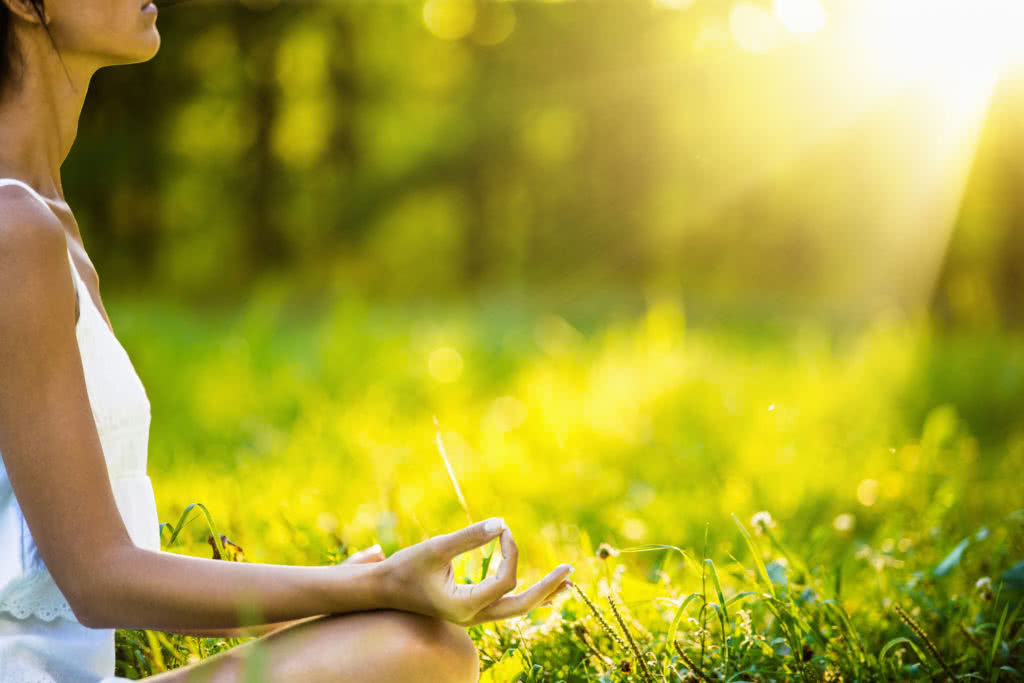 44046119 - yoga woman meditating at sunset. female model meditating in serene harmony