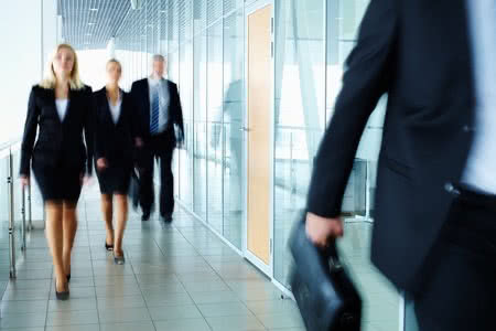 10289799 - business people walking along the office corridor