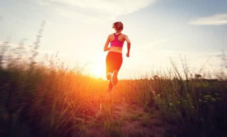 41800751 - young woman running on a rural road at sunset in summer field. lifestyle sports background